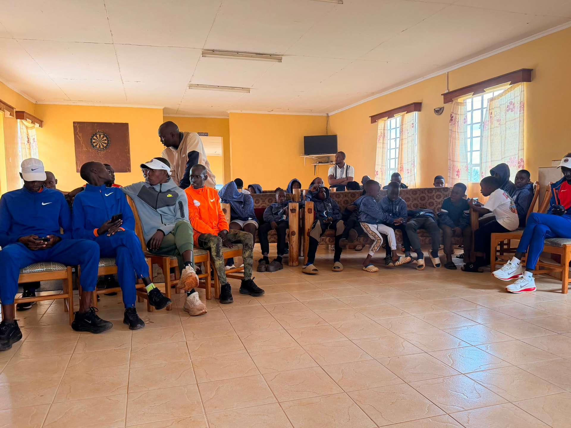 Coaches and players gathered in a hall for an academy education session